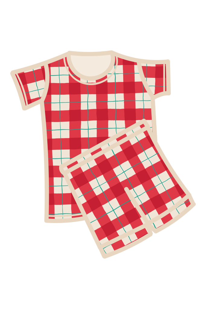 A two-piece kids pyjama set featuring a short-sleeve top and matching shorts in a red, white, and green tartan, with a cream-colored collar, pocket, and drawstring. Made from organic cotton
