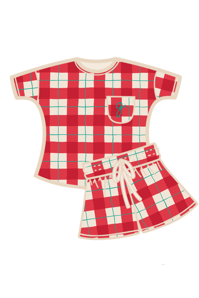 A two-piece teen pyjama set featuring a short-sleeve top and matching shorts in a red, white, and green tartan, with a cream-colored collar, pocket, and drawstring. Made from organic cotton