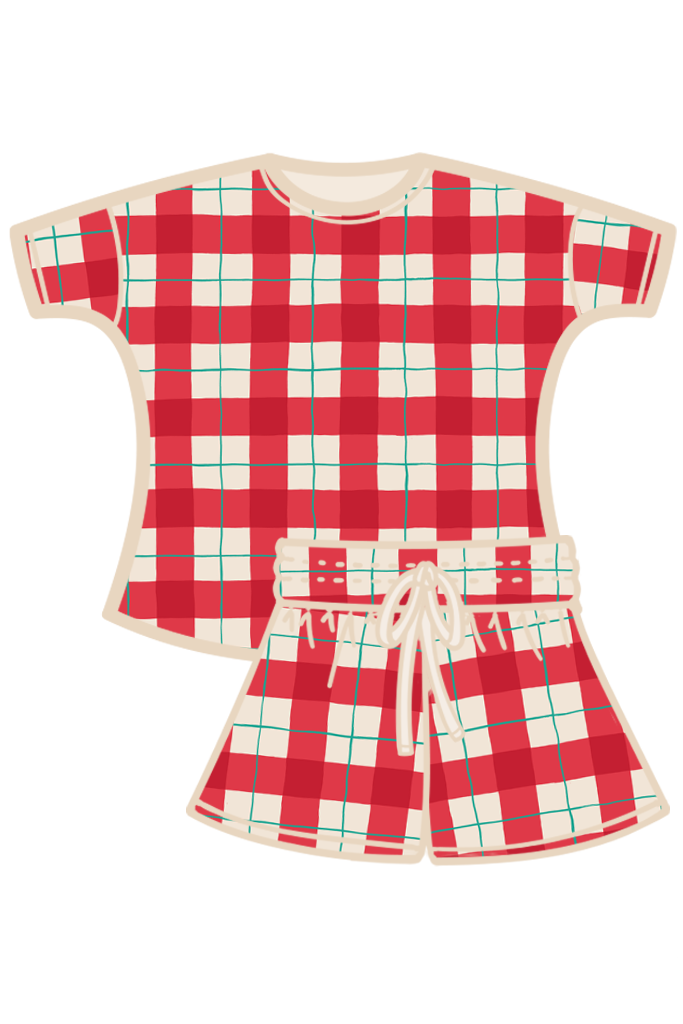 A two-piece women's pyjama set featuring a short-sleeve top and matching shorts in a red, white, and green tartan, with a cream-colored collar, pocket, and drawstring. Made from organic cotton